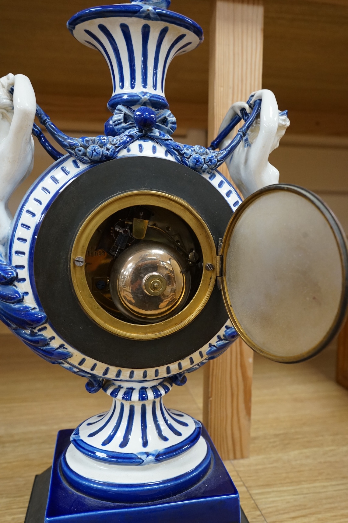 An early 20th century figural glazed ceramic mantle clock, 21cm wide x 40cm high
